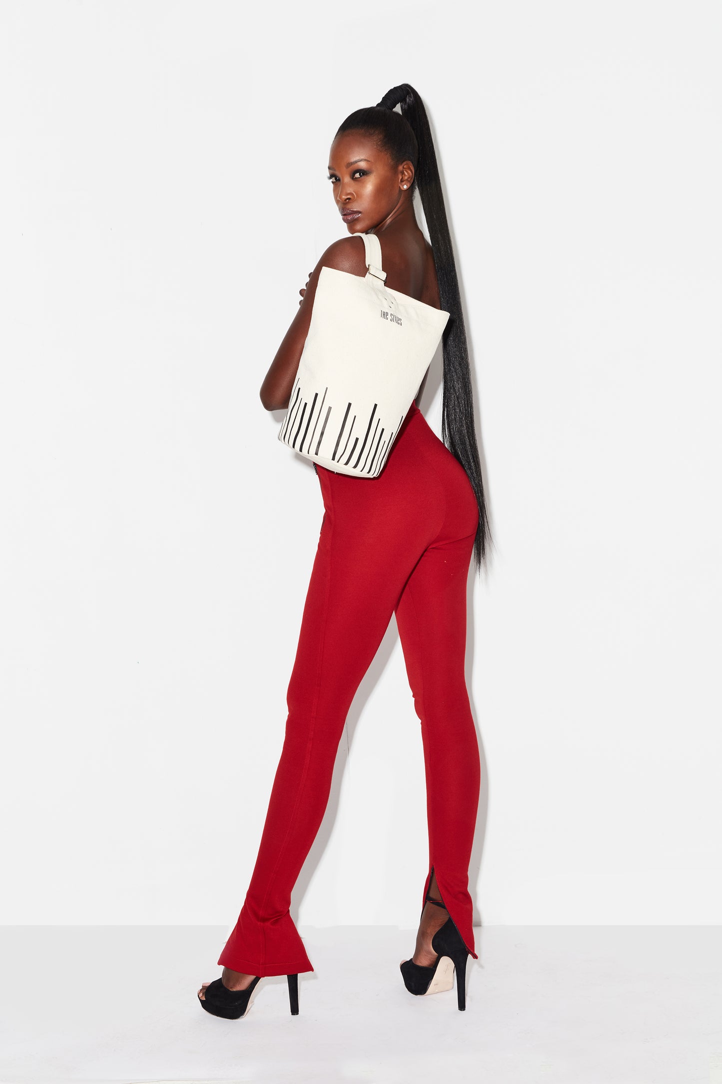 Heavy-duty canvas tote with vertical black lines at the base. From The Sixes.
