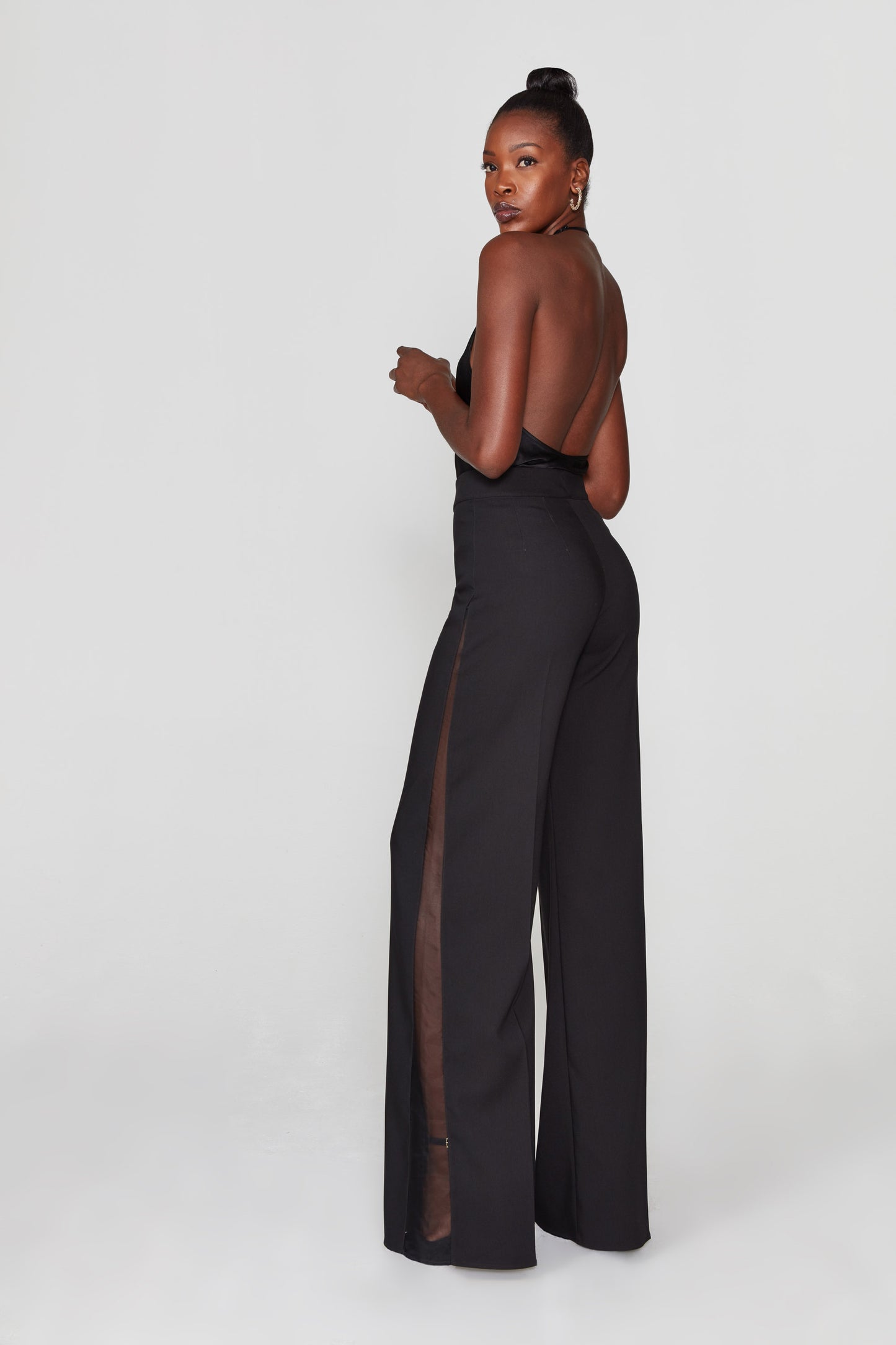 Black wide-leg pants with sheer black organza sides. From The Sixes.